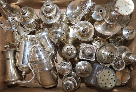 22 silver peppers (inc one pair), various shapes, dates and makers and a pair of silver-mounted glass peppers